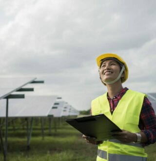 Engineer electric woman checking and maintenance of solar cells.